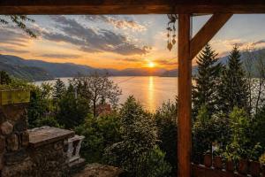 a view of a sunset from a window of a house at Smart Nature in Donji Milanovac