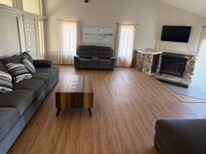 a living room with a couch and a fireplace at Mountain Hideway in Coarsegold