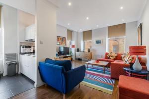 a living room with a couch and a table at Blackfriars Cosy Retreat in Glasgow