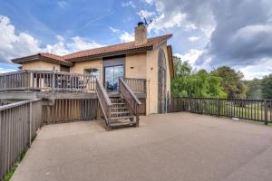 a house with a large deck and a fence at Mountain Hideway in Coarsegold