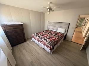 a bedroom with a bed and a ceiling fan at Mountain Hideway in Coarsegold