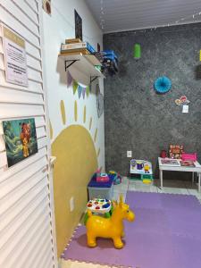 a room with a toy horse in the corner of a room at Suite Lilo e Stitch - Pousada Castelo do Luar in Penha