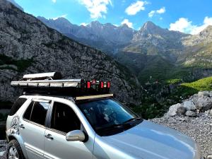 a car parked on the side of a mountain at car camping rental in Shkodër +15 photos
