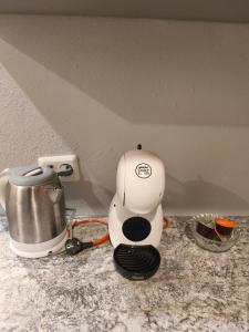 a coffee maker sitting on top of a counter at Patricia Apartments in Vilnius