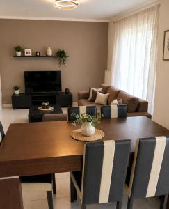 a living room with a table and a couch at Epanomi apartment in Epanomi