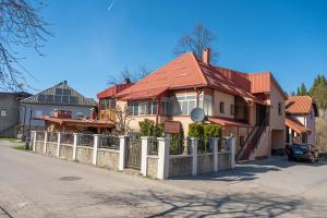 a house with a fence in front of it at Apartmani Dino Kolasin in Kolašin