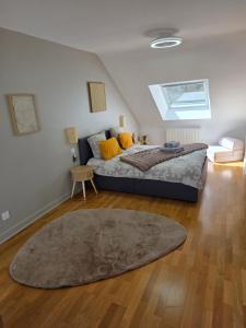 a bedroom with a large bed and a rug at Les appartements du Marché in Dinan