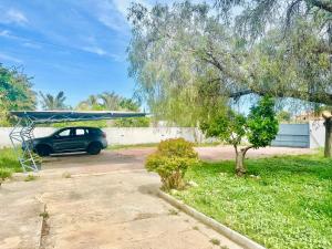 a car parked in a parking lot with a canopy at Alicante Garden & BBQ - Estudio adosado con Jardín, Parking Privado y Relax Total in Alicante