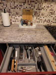 a kitchen drawer with utensils on a counter at Patricia Apartments in Vilnius