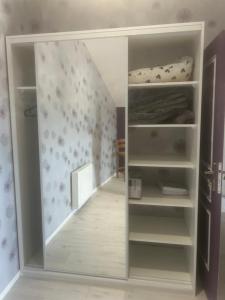 a room with a closet with a bed in it at Au Petit Bouchon in Le Breuil