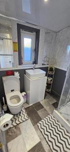 a bathroom with a white toilet and a sink at Westview in Buckie +53 photos