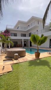 a villa with a swimming pool and a house at Paradise View Villas in Malindi