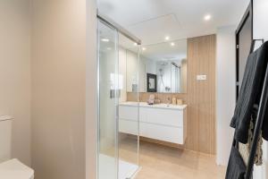 a bathroom with a glass shower and a sink at Los Naranjos House in Marbella +28 photos