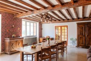 a large dining room with a table and chairs at Bienvenue chez Pépère in Nitry