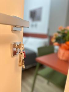 a set of keys hanging from a door handle at B&B Piano B in Riva del Garda