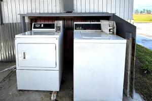 two old refrigerators are sitting under a table at Briarwood Motel Near Valdosta University I 75 in Valdosta