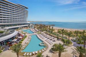 an aerial view of a resort with a pool and beach at Waldorf Astoria Doha Lusail in Doha
