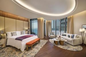 a bedroom with a large bed and a living room at Waldorf Astoria Doha Lusail in Doha +119 photos