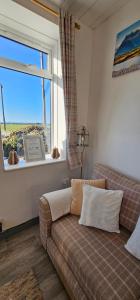 a living room with a couch and a window at Westview in Buckie