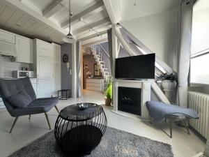 a living room with a television and a table and chairs at Haus Christine in Traben-Trarbach in Traben-Trarbach