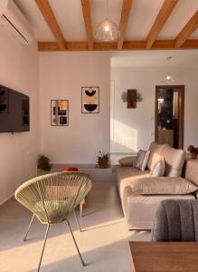 a living room with a couch and a chair at Klima Breeze in Klíma