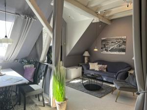 a living room with a couch and a table and chairs at Haus Christine in Traben-Trarbach in Traben-Trarbach