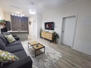 a living room with a couch and a table at River Apartman 2 in Odorheiu Secuiesc