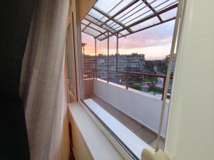 a balcony with a window with a view of a city at One-Bedroom flat Meden Rudnik zone B in Burgas