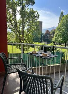 a balcony with two benches and a table with food on it at B&B Piano B in Riva del Garda