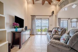 a living room with two couches and a television at Villas Catalina 7 in Potrero