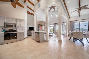 a large kitchen with white cabinets and a table with chairs at Villas Catalina 7 in Potrero