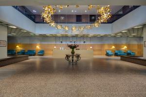 a large room with a table with flowers on it at Pine Astoria Hotel in Tbilisi City +76 photos