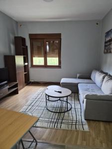 a living room with a couch and a table at Espacio Yina Grado in Grado +4 photos