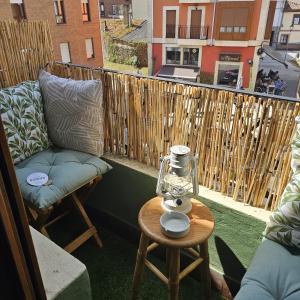 a balcony with a couch and a table on a balcony at Espacio Yina Grado in Grado