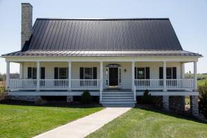 a white house with a gambrel roof at The Gathering Premier stay for Large Groups in Millersburg
