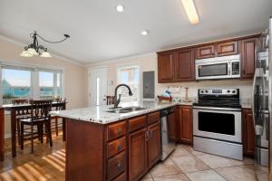 a kitchen with a sink and a stove top oven at This Is It by Oak Island Accommodations in Oak Island
