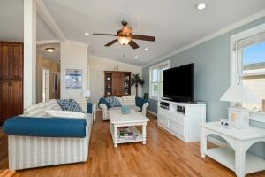 a living room with a couch and a tv at This Is It by Oak Island Accommodations in Oak Island +25 photos