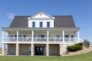 a large white house with a gambrel roof at The Gathering Premier stay for Large Groups in Millersburg