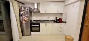 a kitchen with a sink and a refrigerator at Grand süit in Kalkan