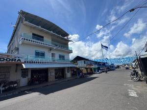 a building with a flag on the side of a street at Pousada Vilasboas in Parintins