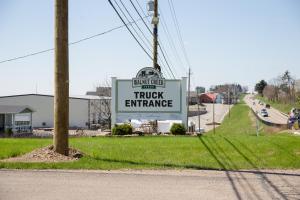 a sign for a truck entrance on the side of a road at The Gathering Premier stay for Large Groups in Millersburg