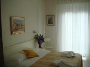 Uma cama ou camas num quarto em Hotel Arcade
