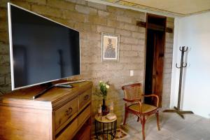 a television on top of a dresser in a living room at Hotel Boutique Rincon Sagrado in Atlixco