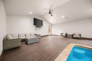 a living room with a couch and a swimming pool at Rare Indoor Pool, Game Room & Courts, 5 Blocks to Snow Summit in Big Bear Lake +64 photos