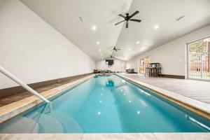 a swimming pool with blue water in a building at Rare Indoor Pool, Game Room & Courts, 5 Blocks to Snow Summit in Big Bear Lake