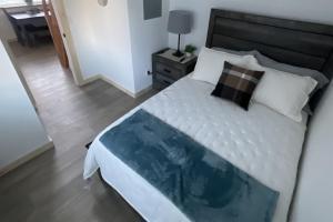 a bedroom with a large white bed and a table at Seward Mountain View Cabins #7 in Seward