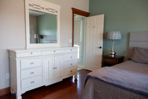 a bedroom with a white dresser and a mirror at The Gathering Premier stay for Large Groups in Millersburg +60 photos