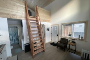 a room with a staircase and a chair at Seward Mountain View Cabins #7 in Seward +11 photos