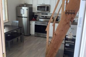 a kitchen with a staircase leading up to a kitchen at Seward Mountain View Cabins #7 in Seward