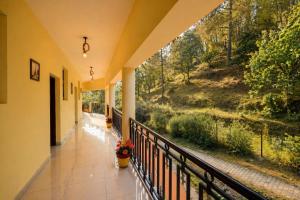 a balcony with a view of a forest at The Regal IVY Hotel in Nainital